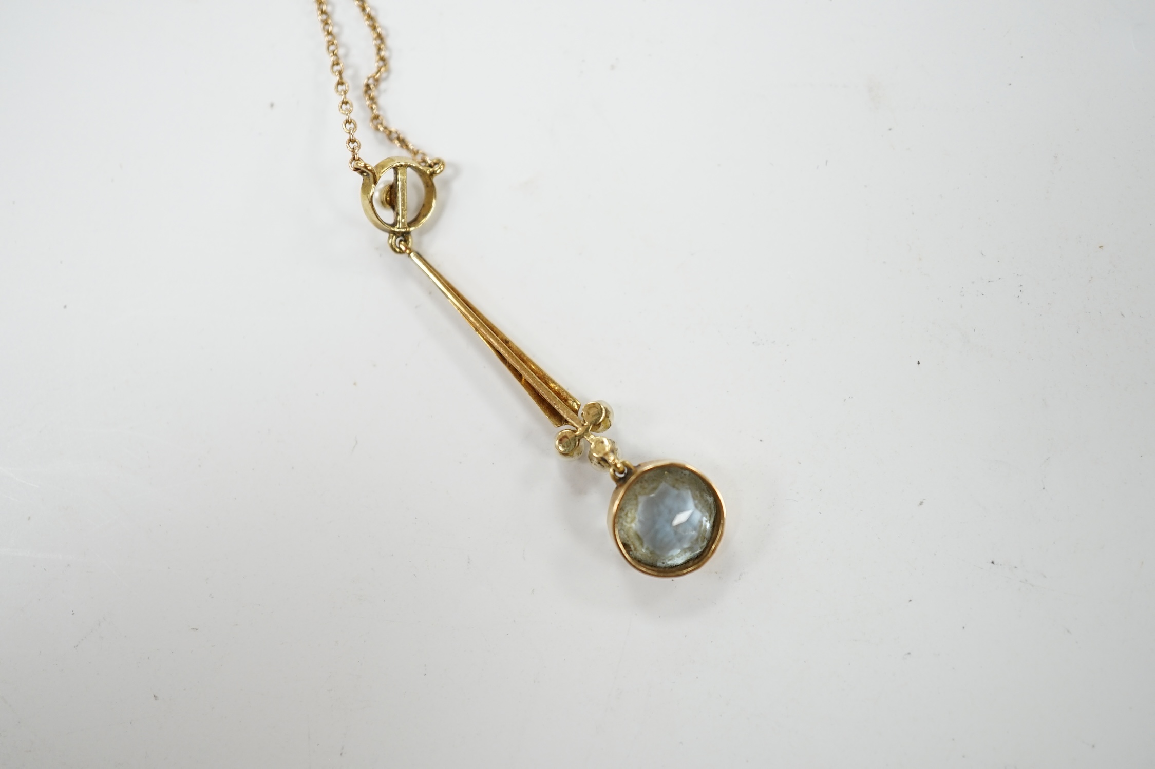 An Edwardian 15ct, aquamarine and seed pearl set drop pendant necklace, pendant 38mm, chain knotted, gross weight 2.9 grams. Condition - fair